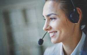 Smiling customer service representative wearing a headset.